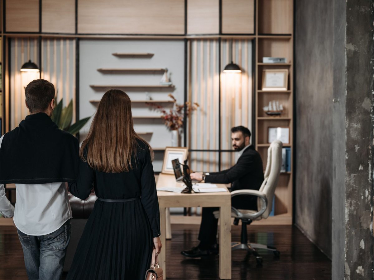Two people arriving for a meeting in a modern office